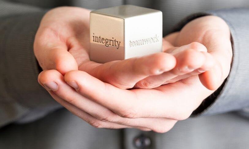 Hands holding blocks representing integrity and trust